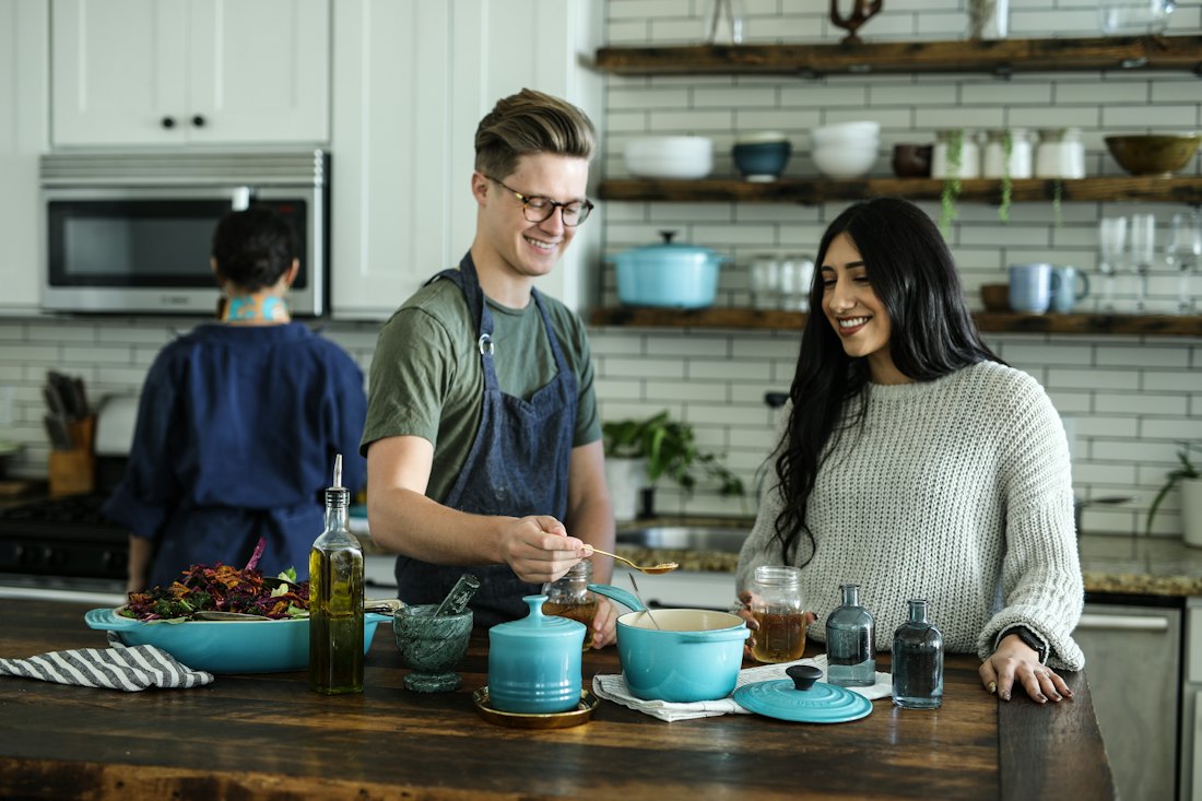 Family cooking supper together in the kitchen